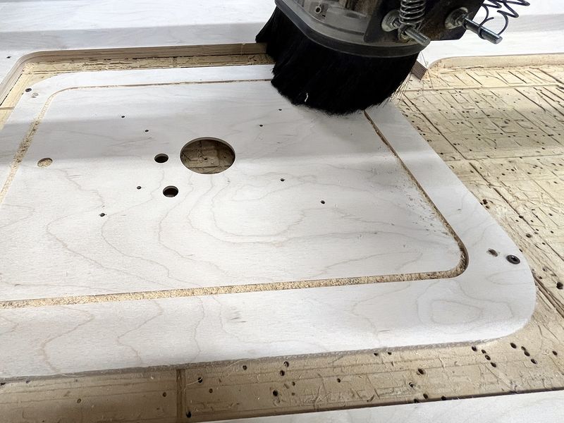 CNC router spindle pocketing a white plastic plate