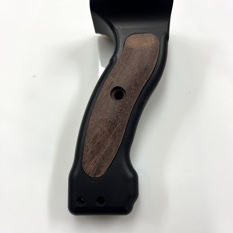 Bow grip handle with the brown hardwood insert in place