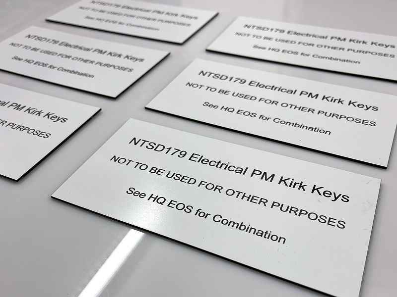 A six-up batch of engraved Kirk key tags
